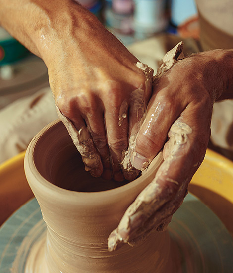A man is making a clay pot